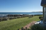 Front lawn with adirondack chairs and incredible ocean views.